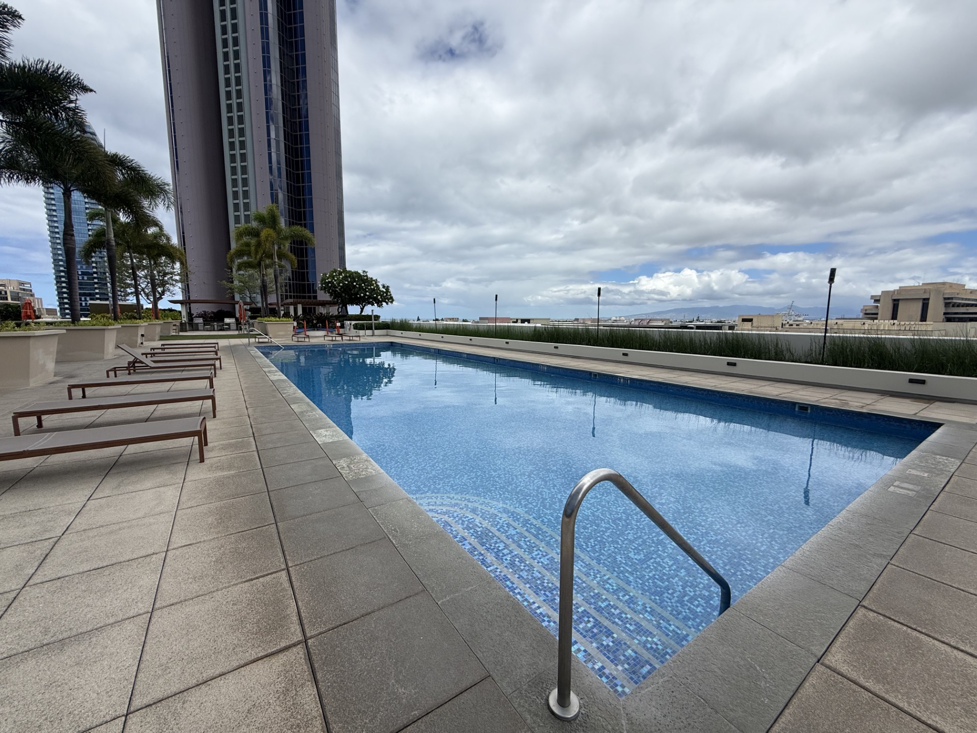 A swimming pool with a metal ladder in the middle of it.